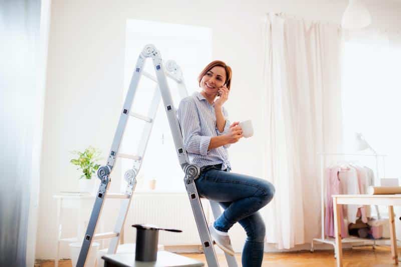 woman sitting on a ladder