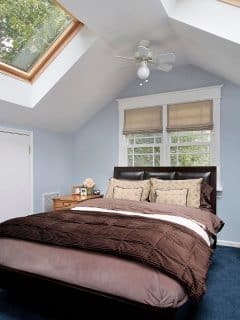 bedroom with skylights and window for lots of natural light