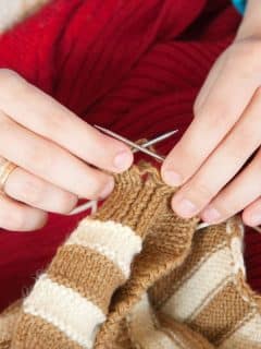 closeup of a pair of hands knitting