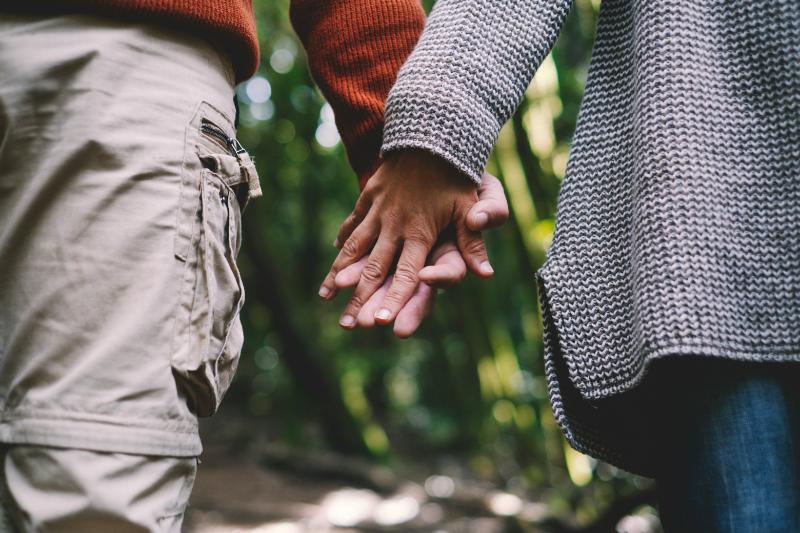 couple holding hands outdoors