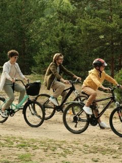father, mother, and son riding bikes outdoors