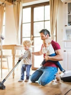 dad and kids cleaning hardwood floors