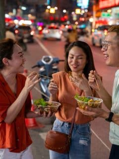 friends eating street food at night