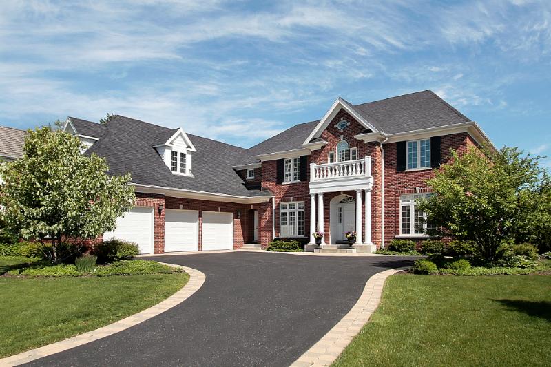 large brick house with shingled roof