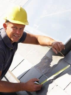 man wearing a hard hat working on a roof