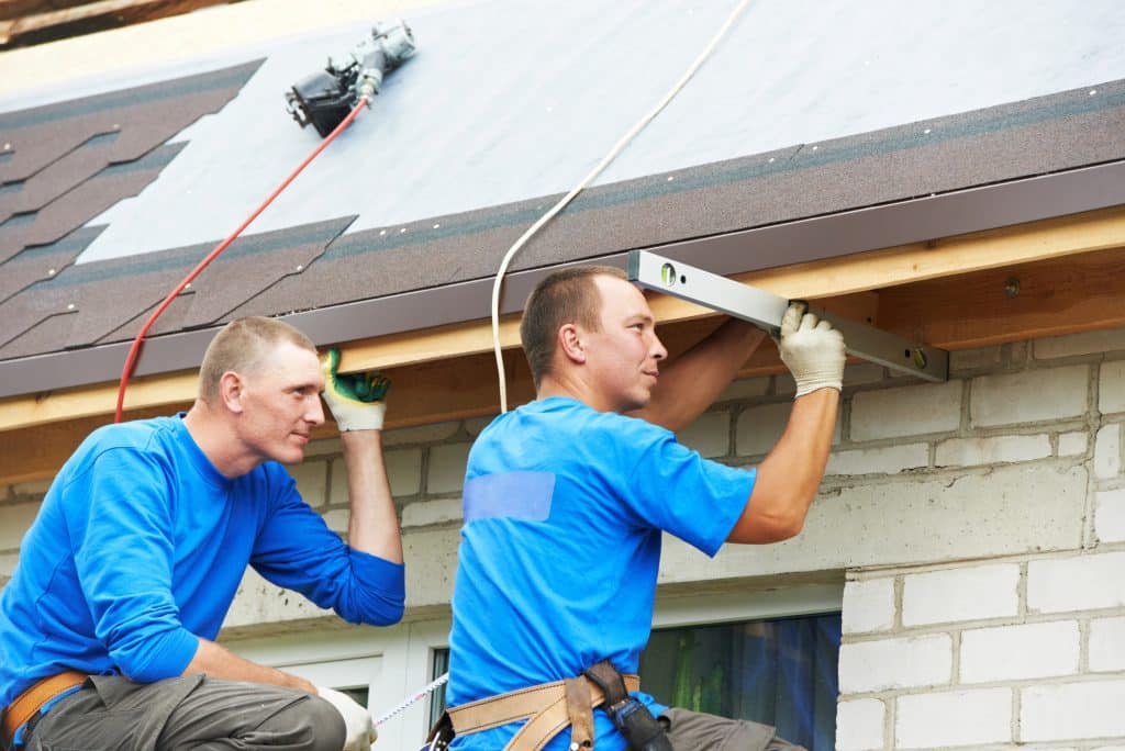 roofers using a level