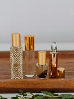 various bottles of perfume on wooden board