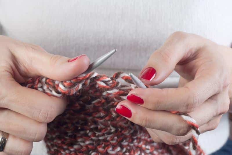 woman's hands knitting - up close view