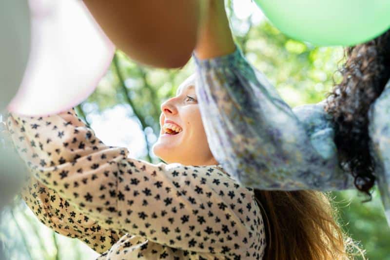 women hanging balloons outdoors