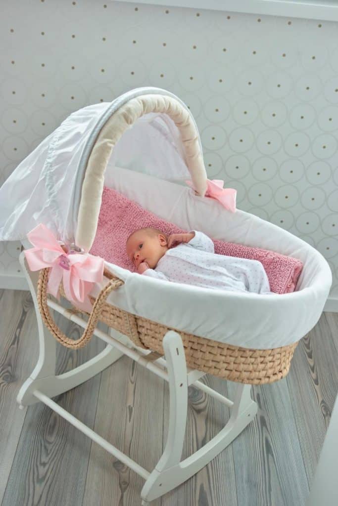 baby girl in bassinet with pink accents
