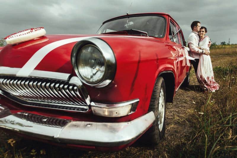 couple beside classic car