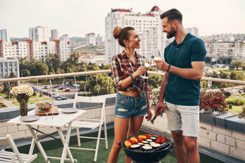 couple cooking on a rooftop patio