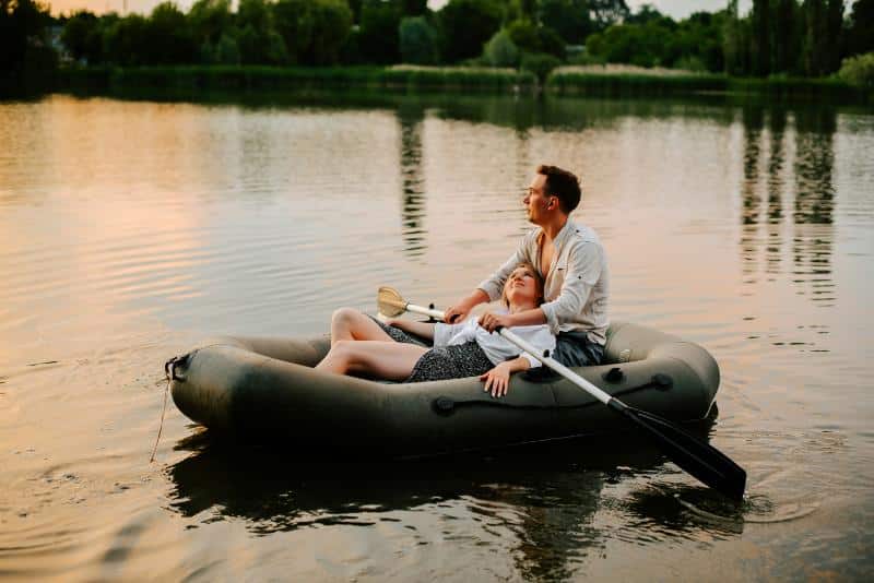 couple floating on water on inflatable raft