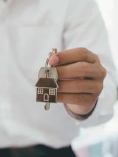 man holding house key