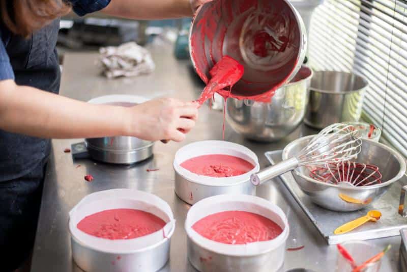 pouring batter into cake pans