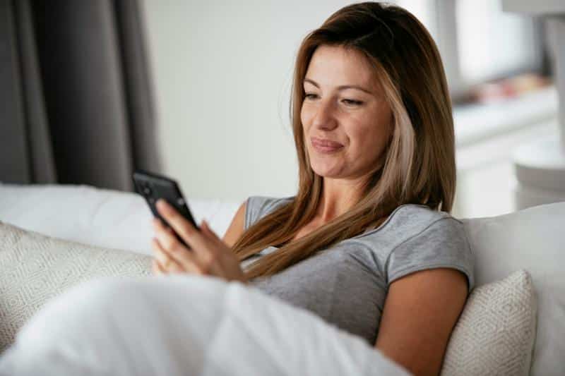 woman looking at phone - screen time