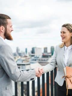 man and woman shaking hands in agreement