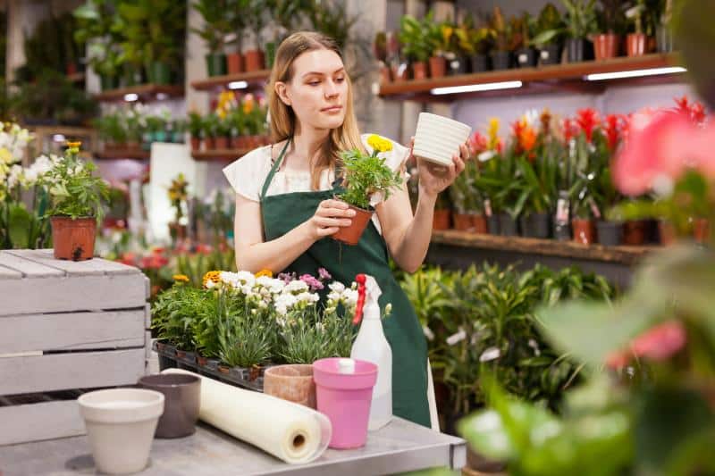 woman looking at potted plants