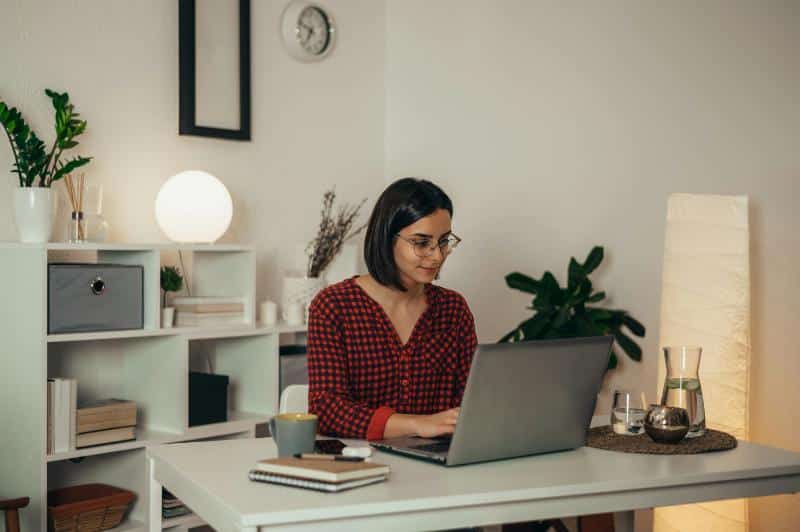 woman in pajamas working in home office