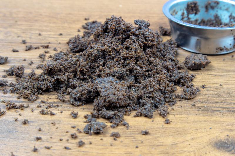 wet coffee grounds on wooden table