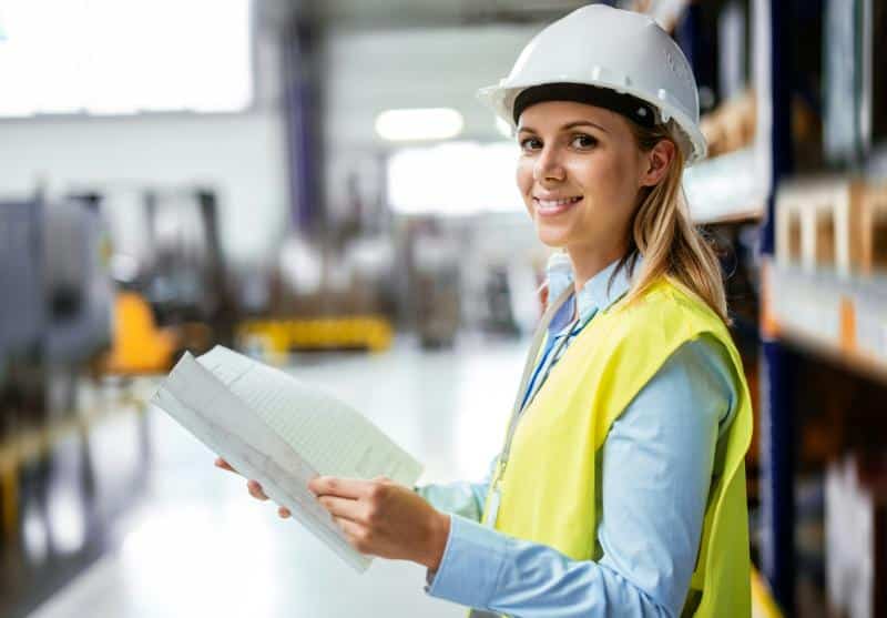 blonde female industrial engineer with white hardhat 