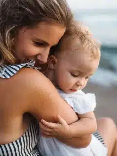 mom and baby daughter on beach