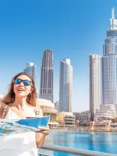woman with sunglasses looking at map in Dubai