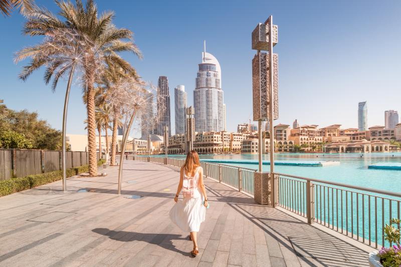 woman walking along the water in Dubai