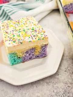 rainbow poke cake on octagonal plate