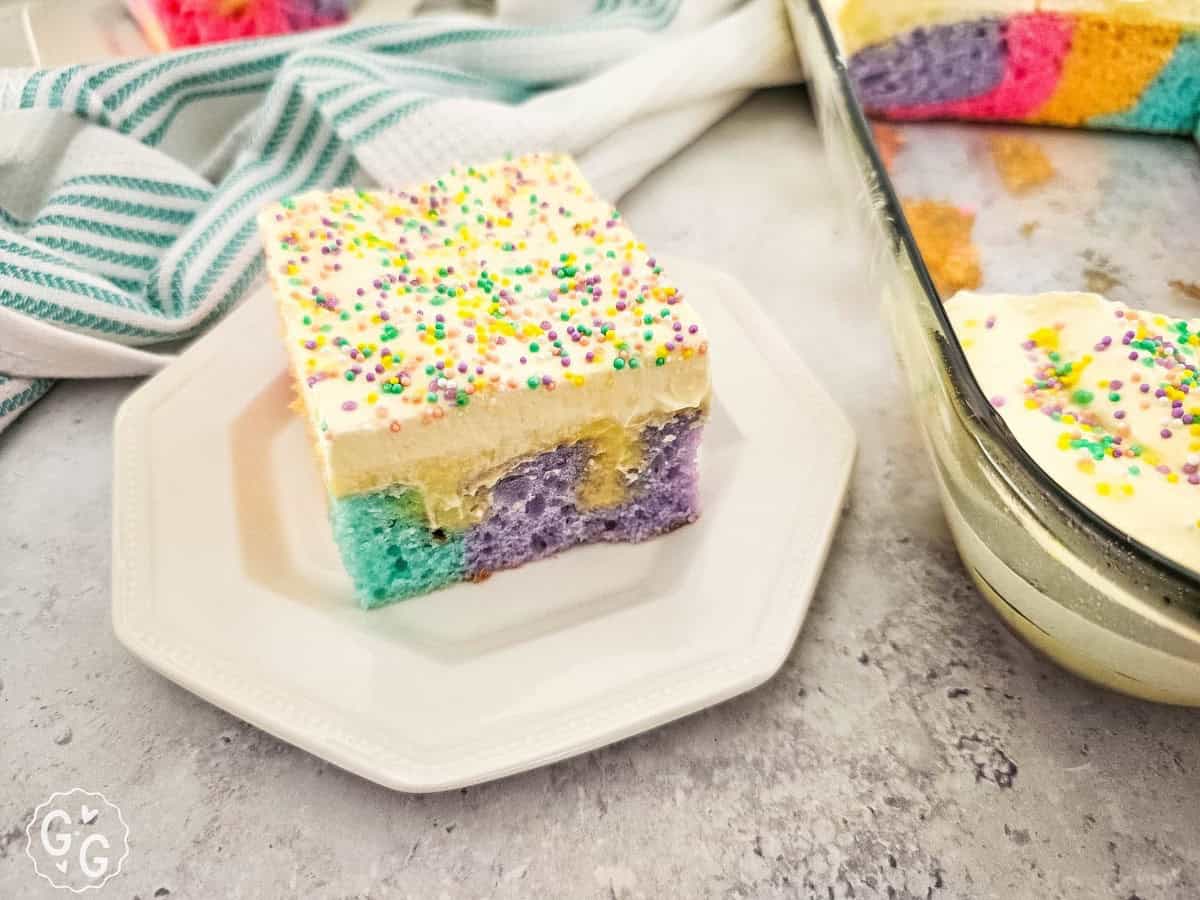 rainbow poke cake on octagonal plate