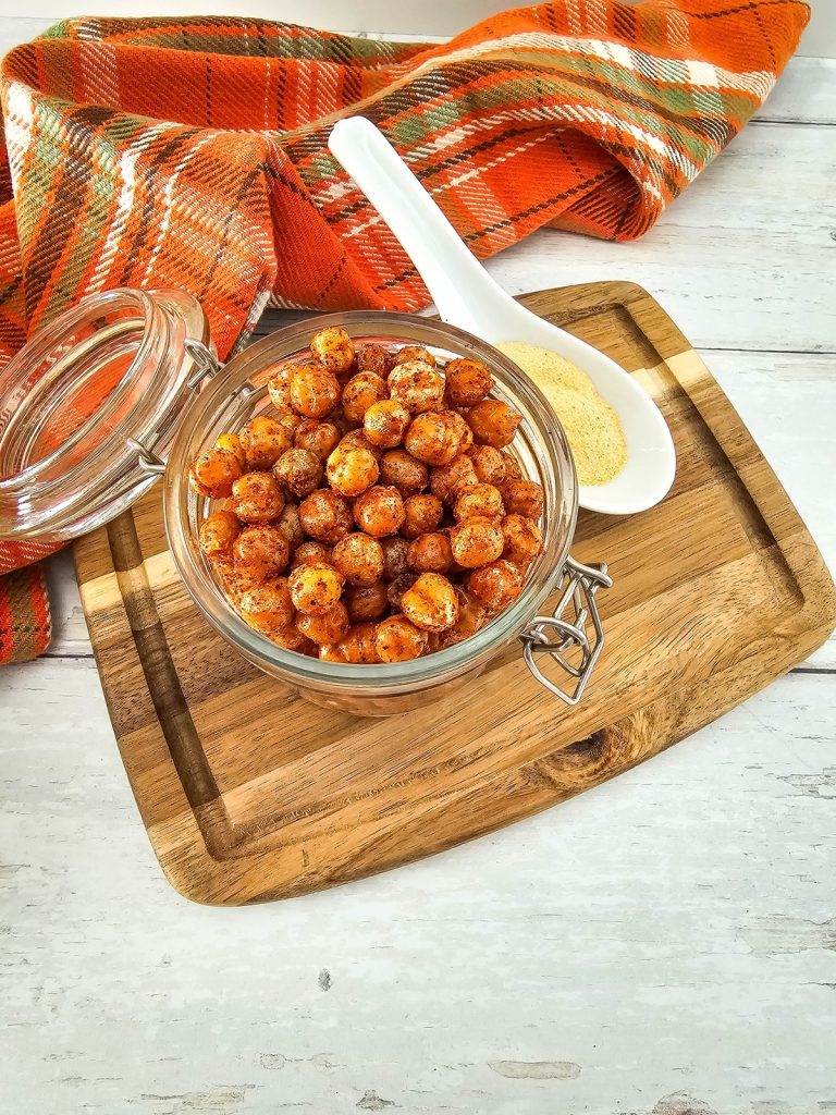 air fryer roasted bbq chickpeas in jar on wooden cutting board