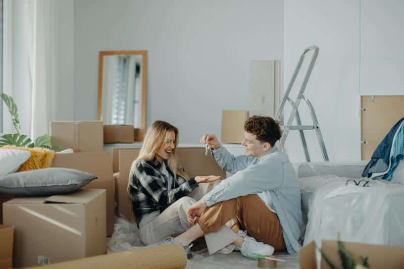 couple in their new home surrounded by boxes to unpack
