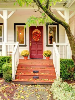 house with a pretty red door and fall wreath