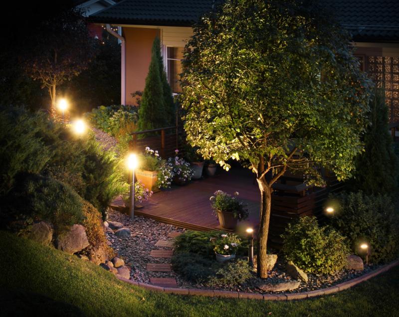 home with outdoor lighting scattered throughout their landscaping