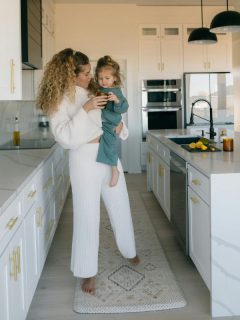 mother holding daughter in kitchen