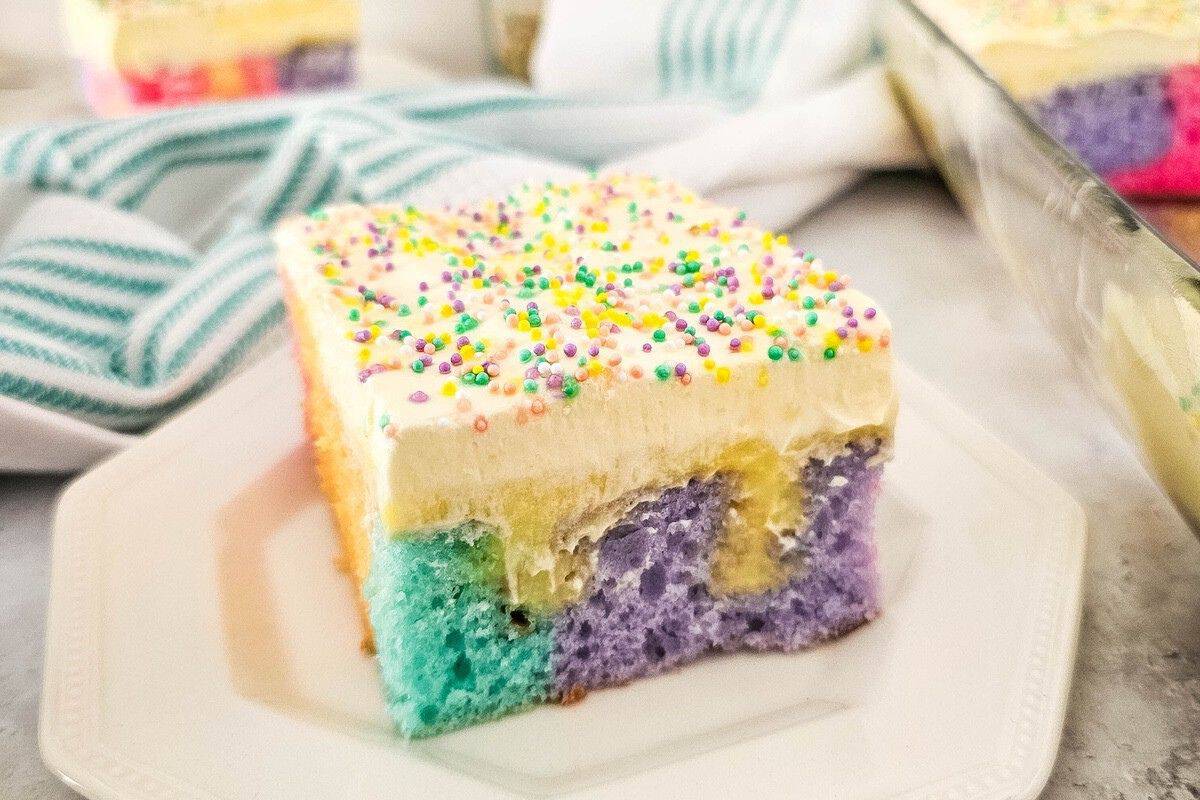 pretty rainbow poke cake on white plate