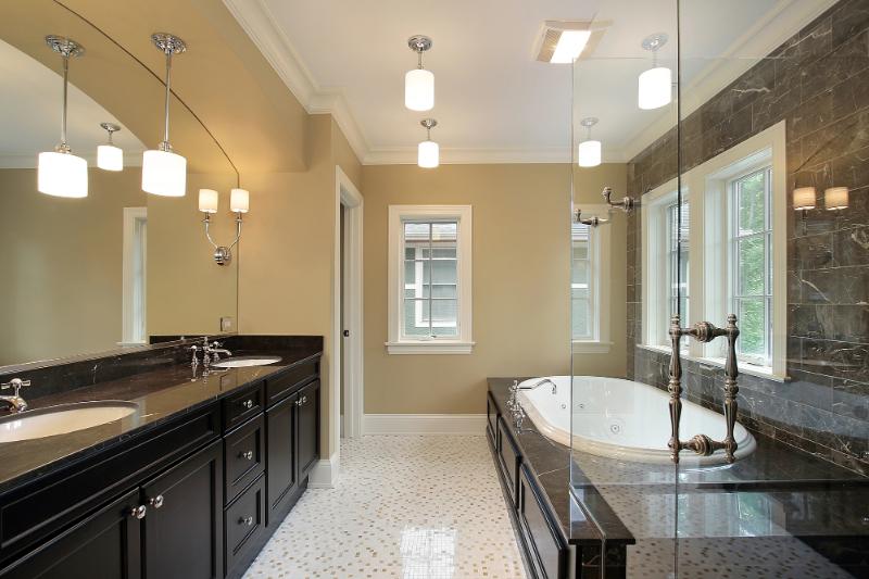 a luxurious master bath with two sinks, a large tub, and a walk-in shower