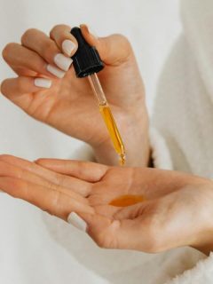 serum in dropper and in a woman's hands