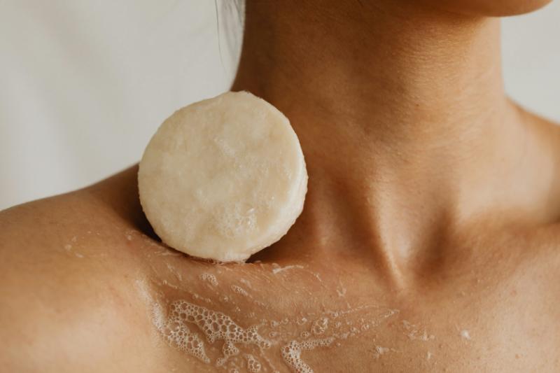 bar of natural soap on woman's collarbone