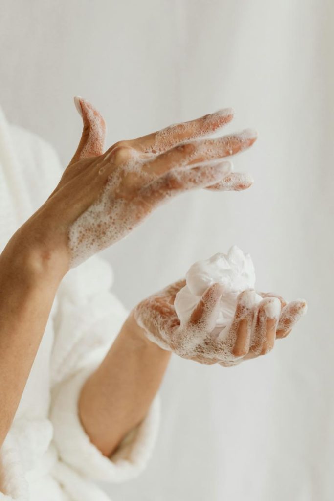 soapy hands holding shaving foam