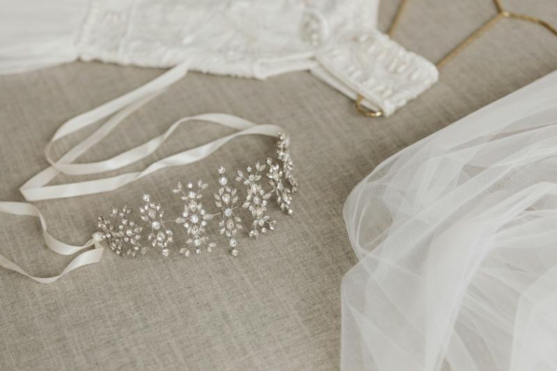 closeup of tiara with veil and wedding dress