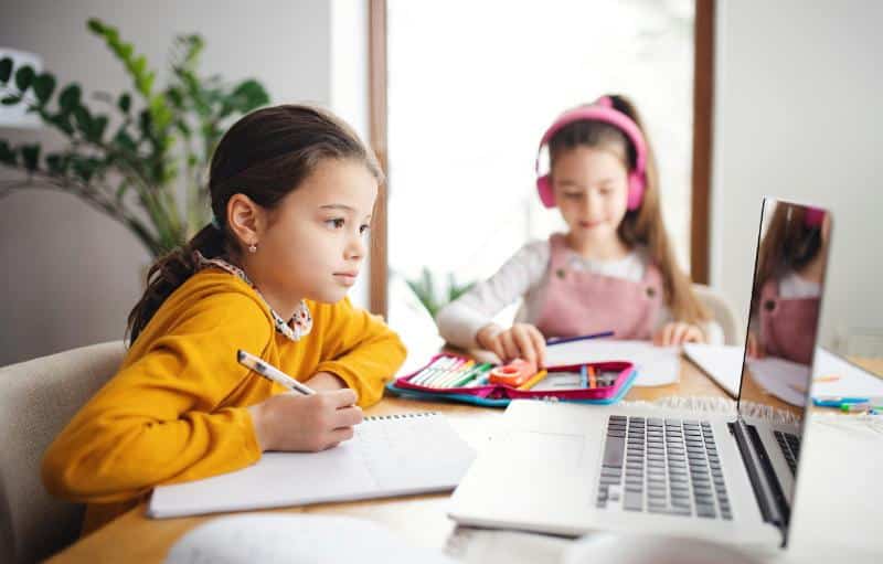 girls working on assignments at a table