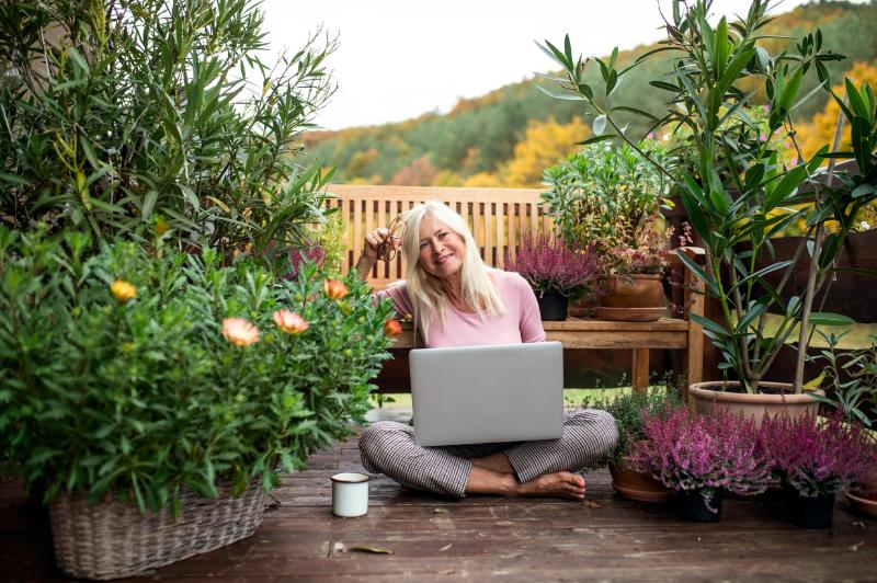 woman surrounded by potted plants
