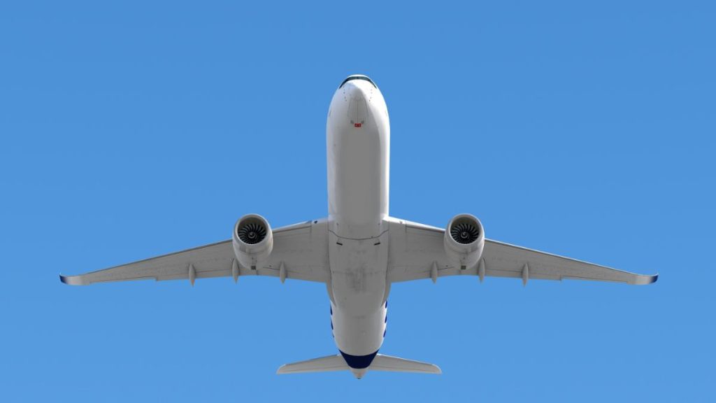 looking up at an airplane flying overhead