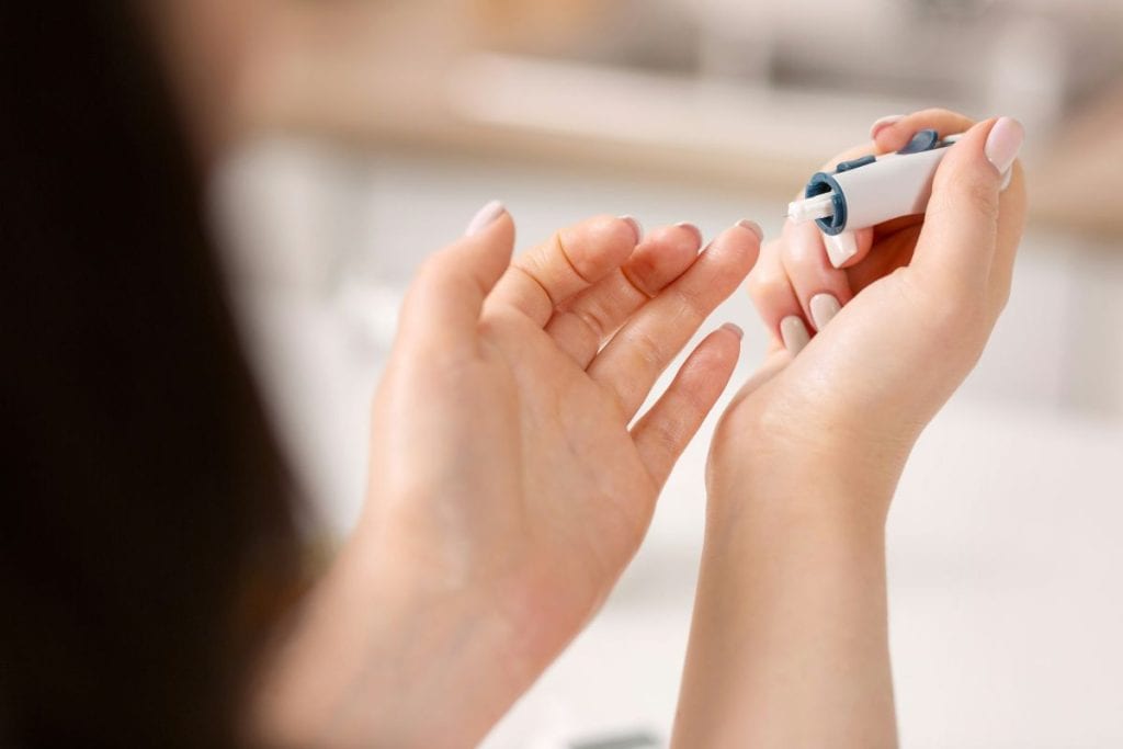 woman doing a blood glucose test