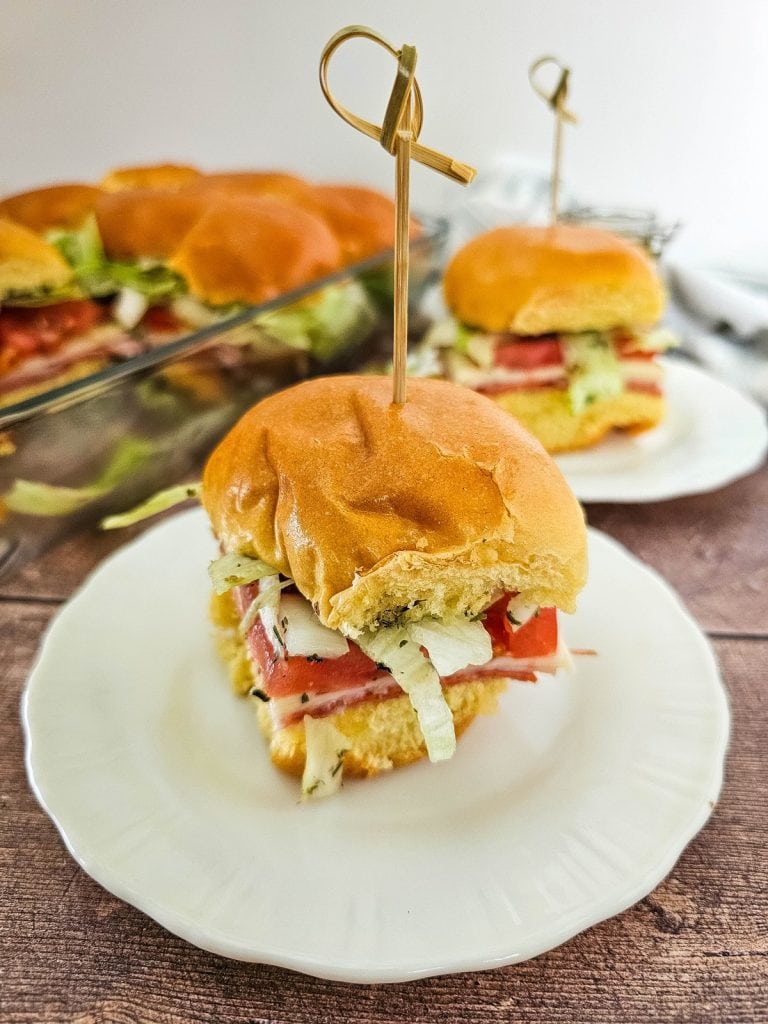 Italian sub sliders with skewers on white plates