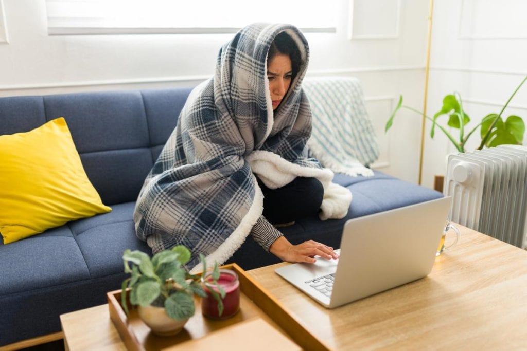 cold woman wrapped in blanket