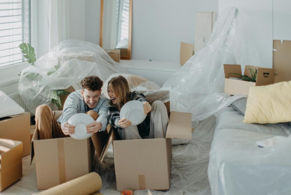 couple having fun unpacking dishes in their new place