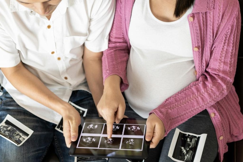 couple looking at ultrasound images