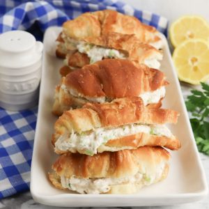 crab salad on croissants on white serving dish